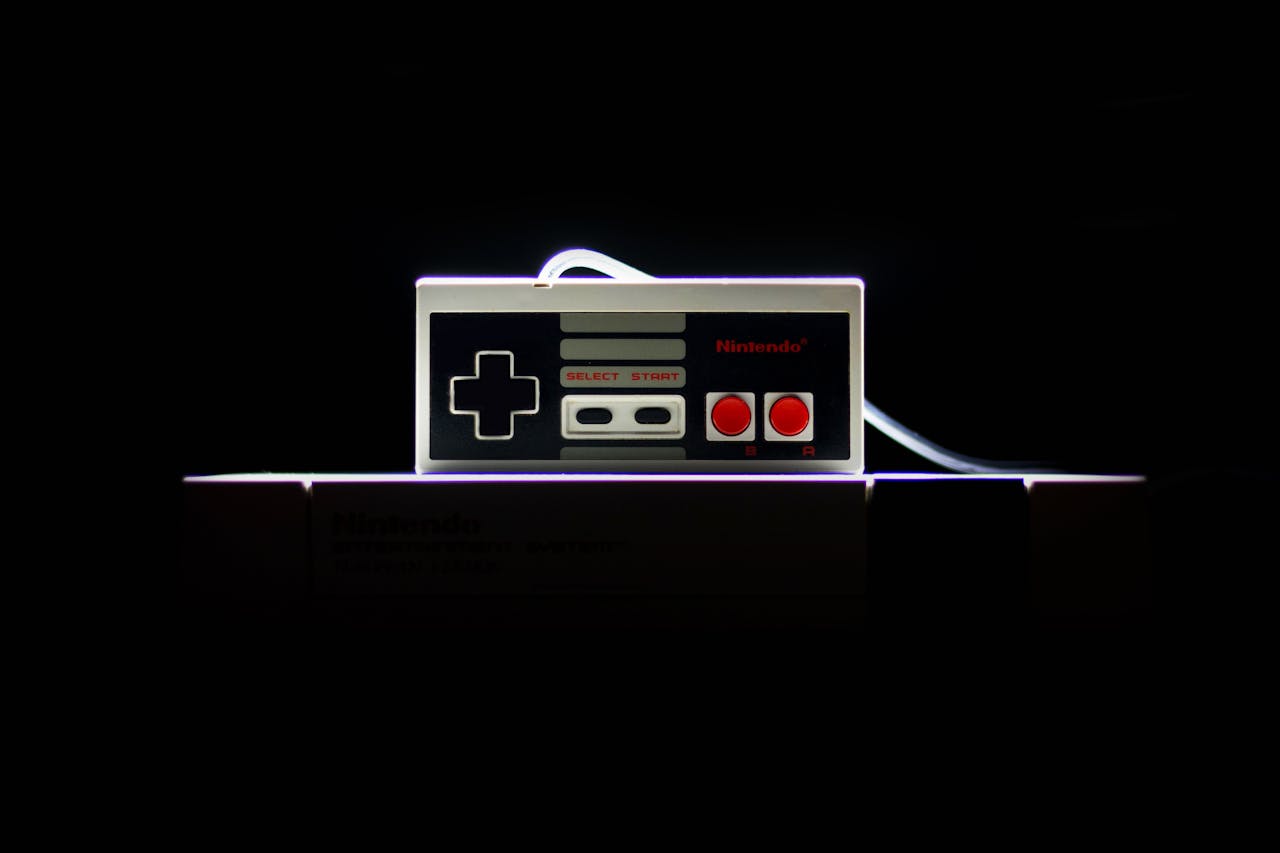 A close-up of a classic NES controller with dramatic lighting on a black background, evoking nostalgia.